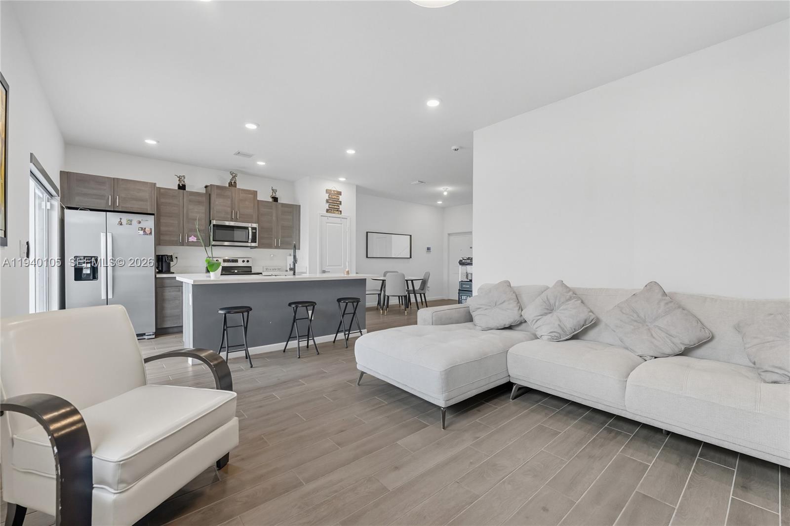 805 South E 18th Street, Unit 805 Homestead, FL 33034 - Photo 7 of 29 a living room with furniture and kitchen view