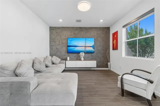 a living room with furniture and a large window