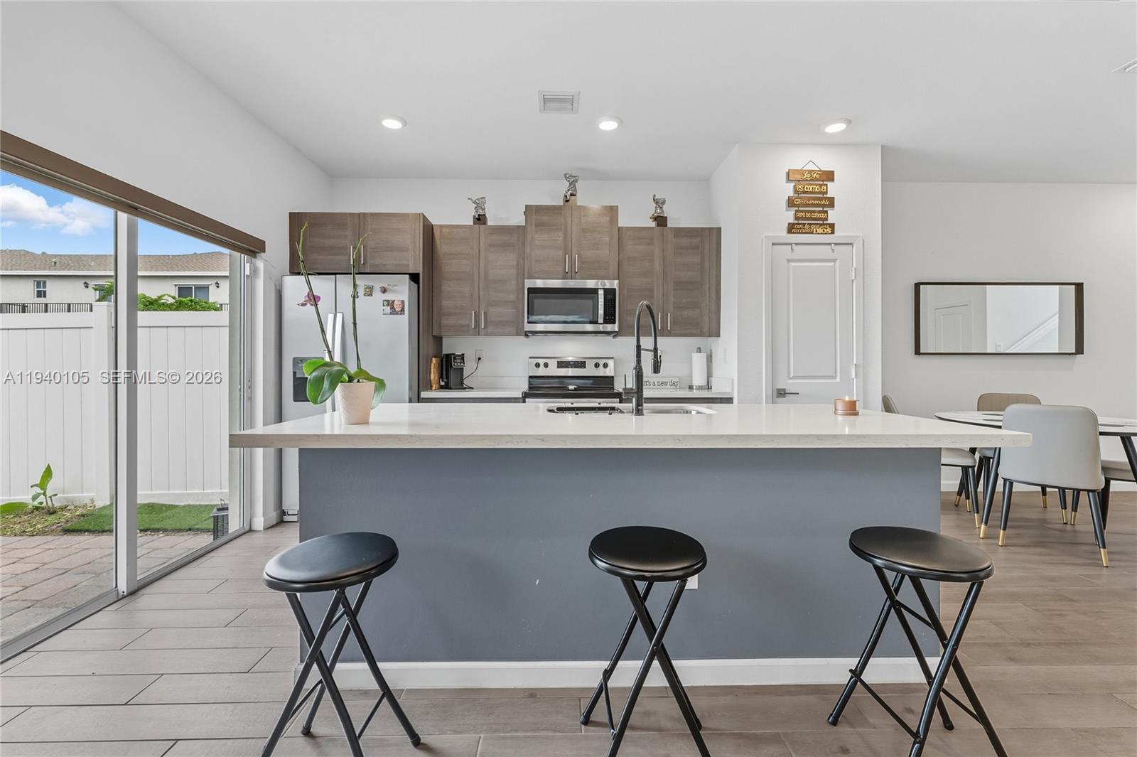 805 South E 18th Street, Unit 805 Homestead, FL 33034 - Photo 10 of 29 a kitchen with a table and chairs in it