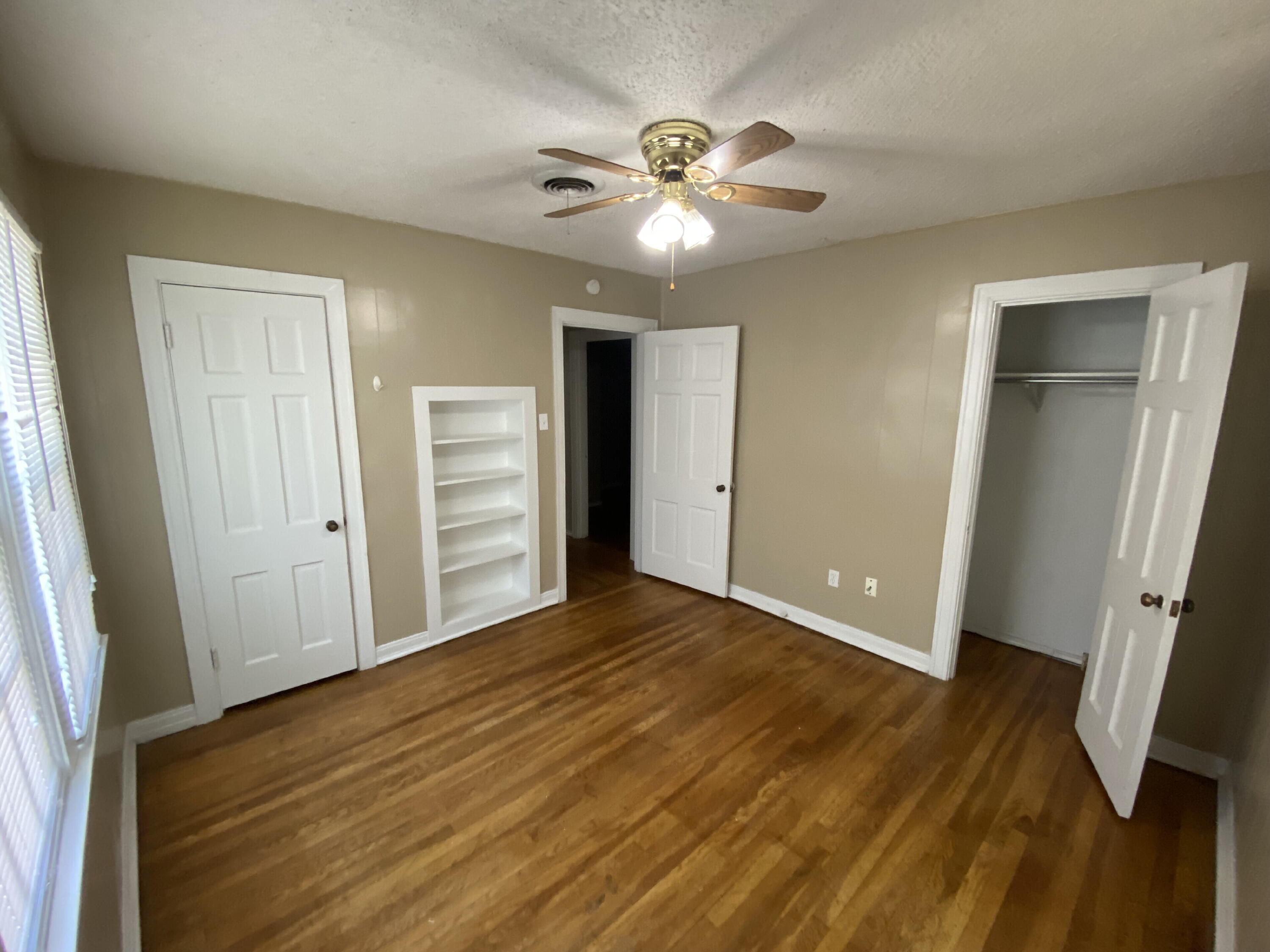 2520 27th Street, Unit FRONT Lubbock, TX 79410 - Photo 15 of 17 a view of a room with wooden floor and staircase