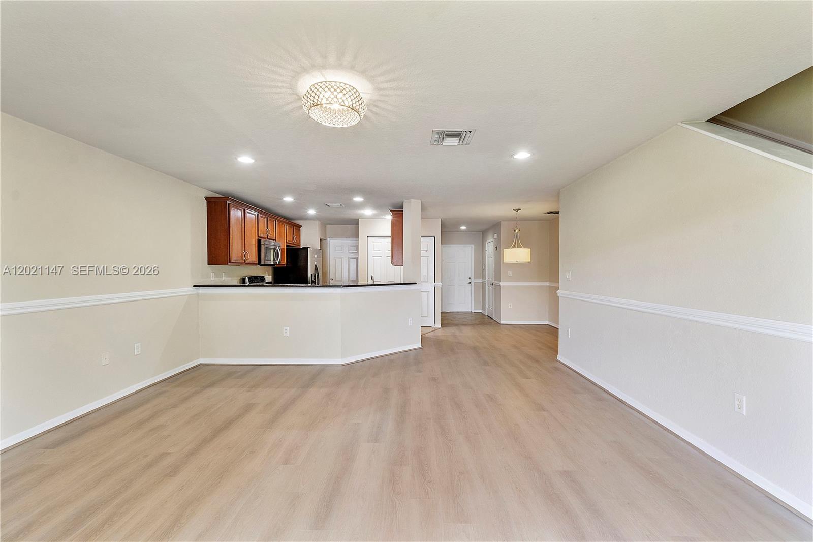 5930 Abbey Road Tamarac, FL 33321 - Photo 5 of 26 a view of kitchen and hall with wooden floor