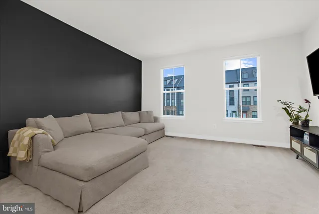 a living room with furniture and windows