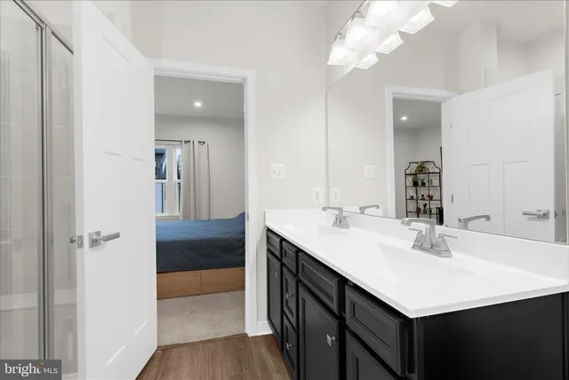 a bathroom with a sink a mirror and a shower