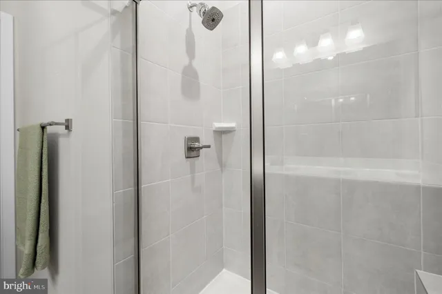a bathroom with a glass shower door