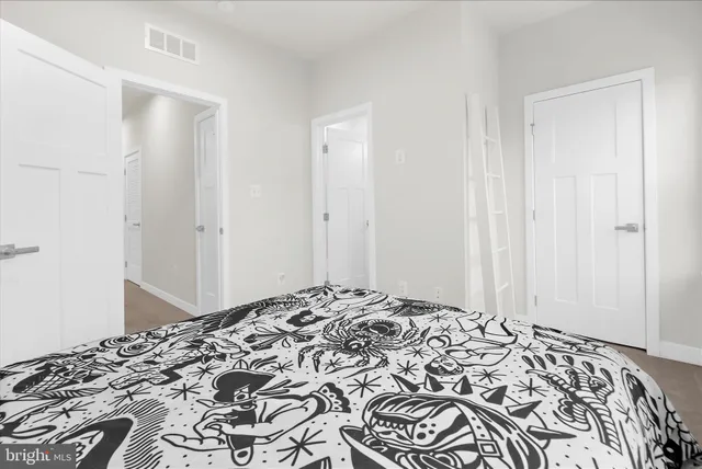 a bed sitting in a bedroom next to a window