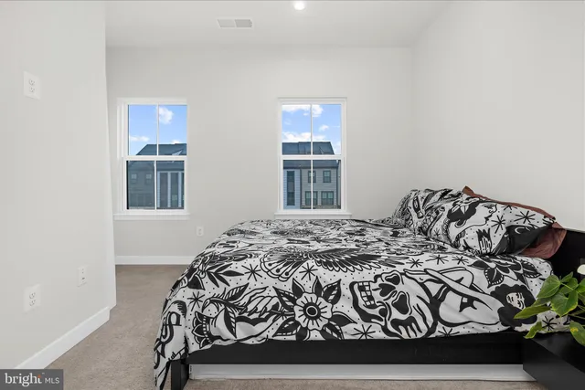 a bathroom with a sink vanity mirror and toilet