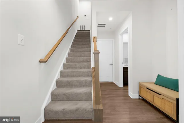 a view of roof deck with a barbeque and wooden stairs