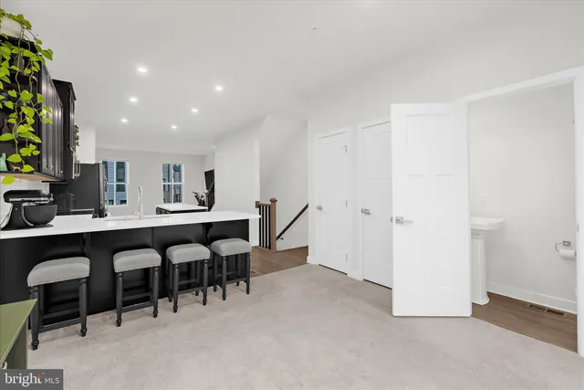 a view of kitchen with dining area and chandelier