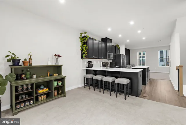 a living room with furniture and a kitchen view