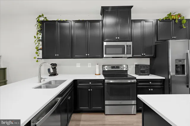 a kitchen with stainless steel appliances and cabinets