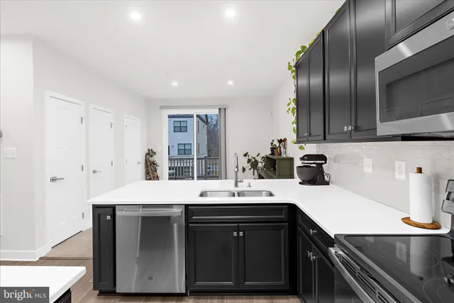 a kitchen with a sink appliances and cabinets