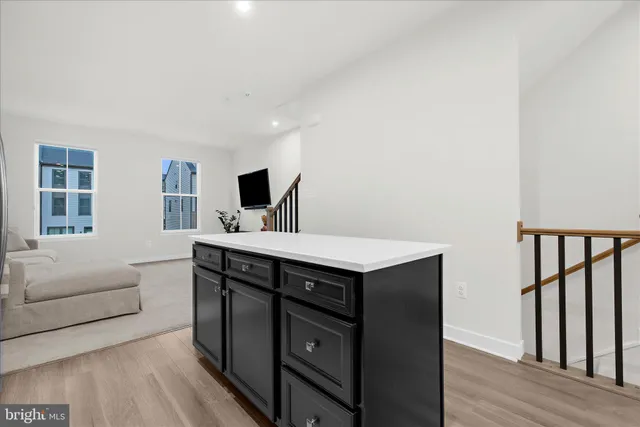 a kitchen with a sink cabinets and wooden floor