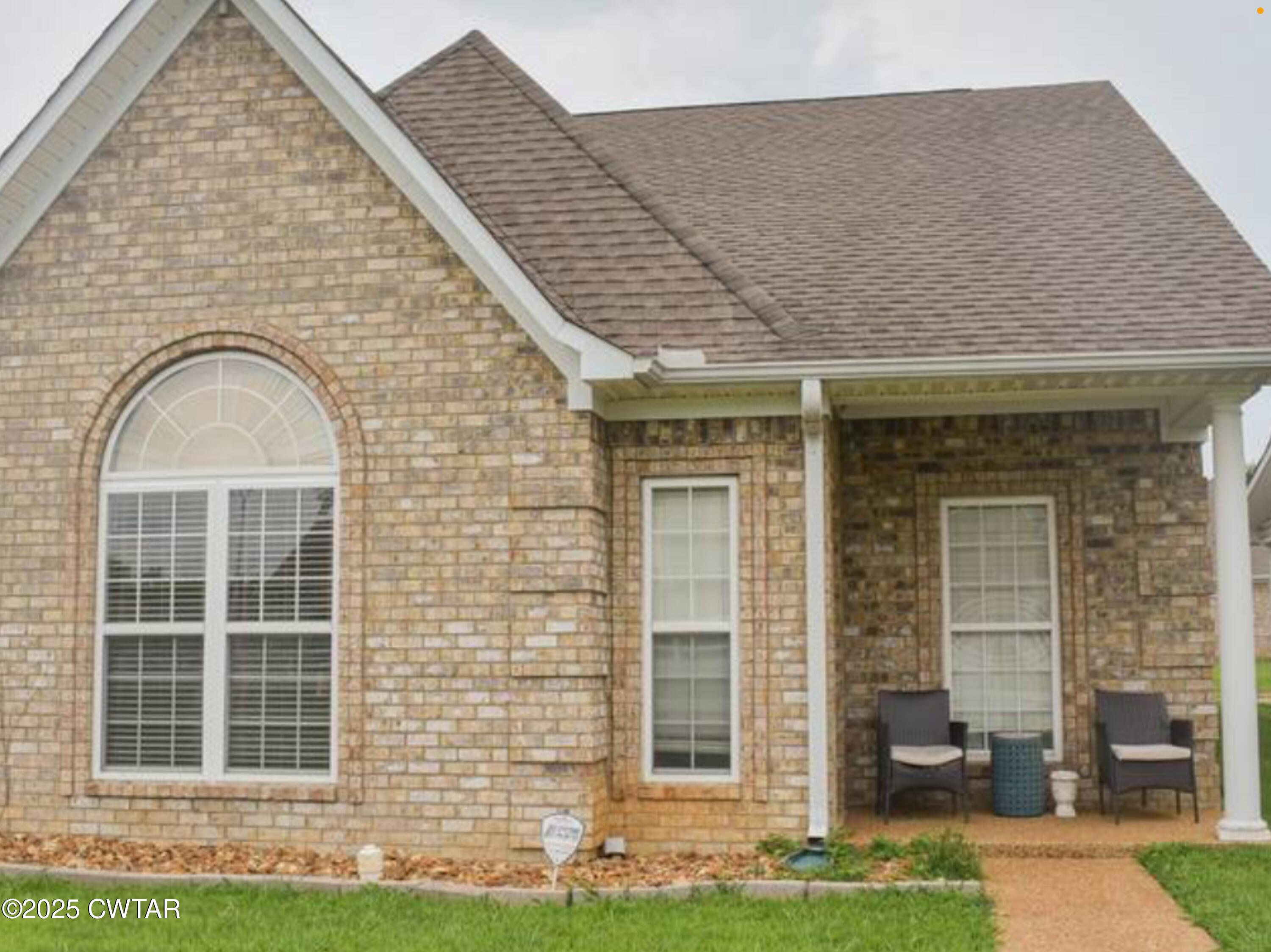 146 Henderson Road Jackson, TN 38305 - Photo 1 of 7 a front view of a house with a garden and plants