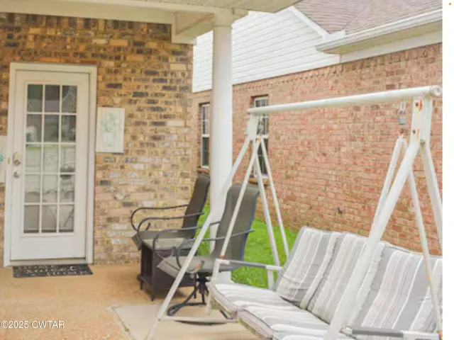 a view of a living room with a furniture and floor to ceiling windows