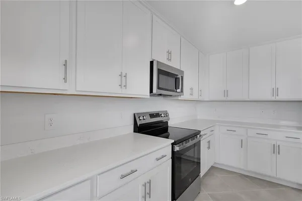 a kitchen with granite countertop a sink and a stove
