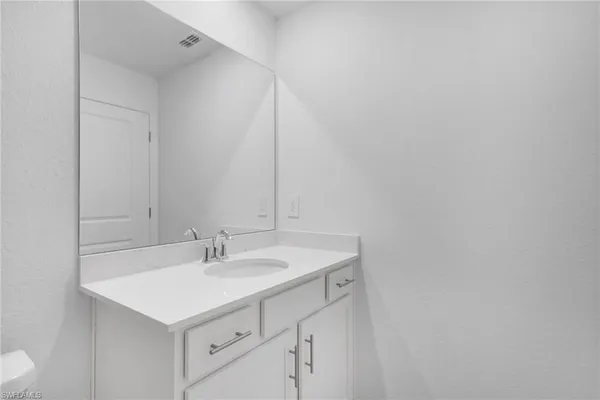 a bathroom with a shower sink and mirror