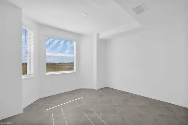 a view of an empty room with a window