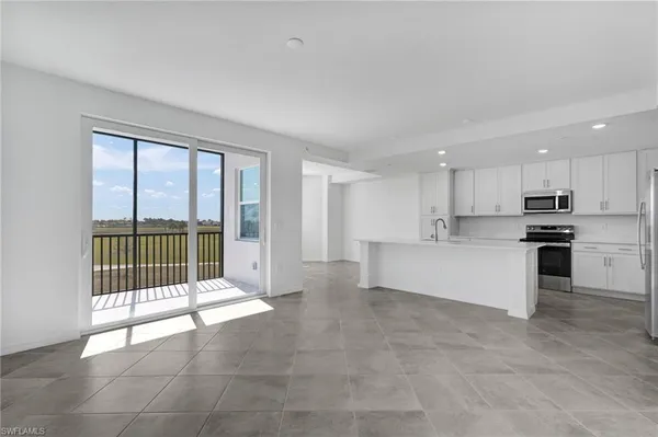 a kitchen with stainless steel appliances a refrigerator a stove top oven a sink and dishwasher