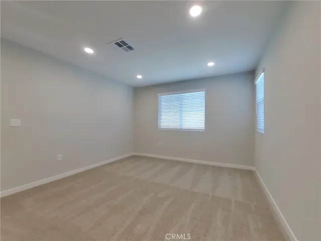 an empty room with a empty space and windows