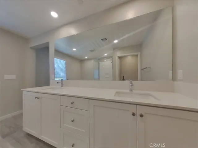 a bathroom with a granite countertop sink mirror and double