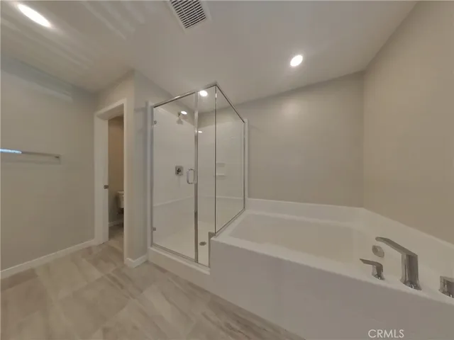 a spacious bathroom with a bathtub and a shower