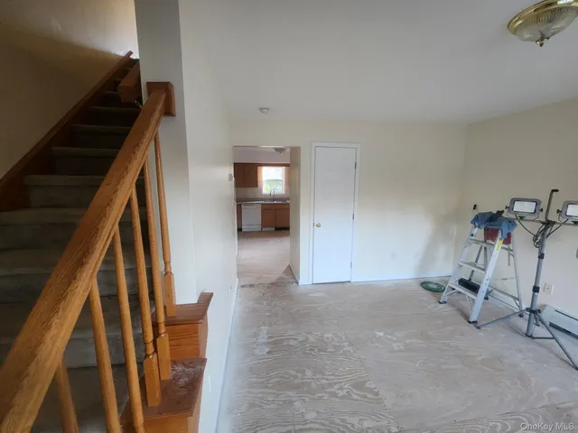 a view of an empty room with stairs