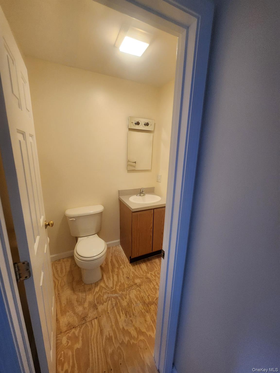 698 South Street, Unit 2 Highland, NY 12528 - Photo 6 of 16 a bathroom with a sink a toilet and a mirror