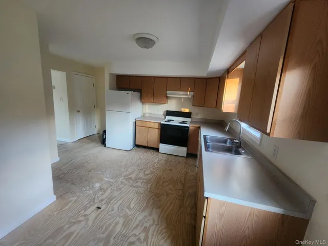 a kitchen with a refrigerator and a sink