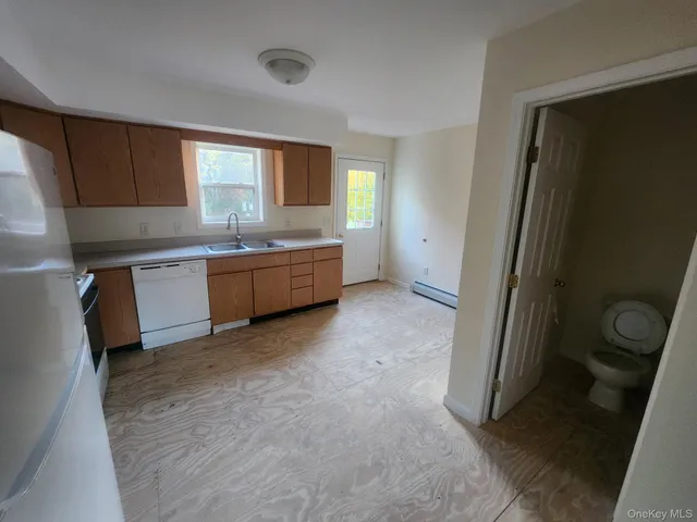 a large kitchen with a sink stove and refrigerator
