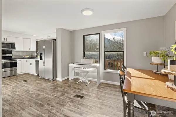 a kitchen with refrigerator cabinets and wooden floor