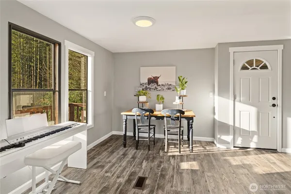 a dining room with wooden floor and a window