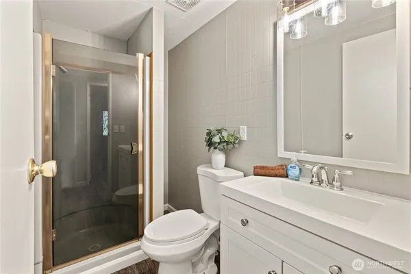 a bathroom with a sink toilet and shower