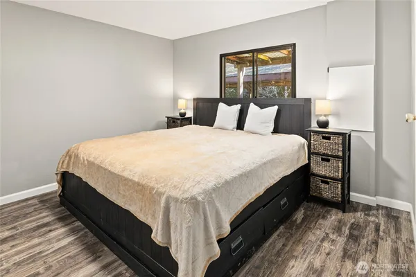 a bed sitting in a bedroom next to a window