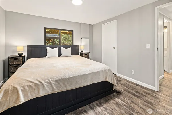 a bedroom with a large bed and a window