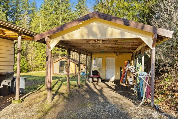 a white house sitting in middle of the middle of a yard