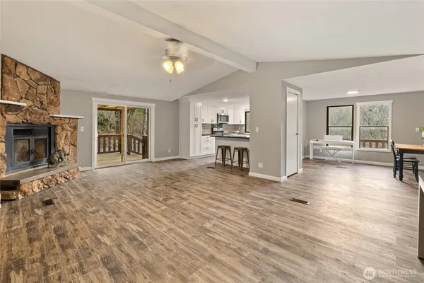 a view of a livingroom with furniture and a kitchen
