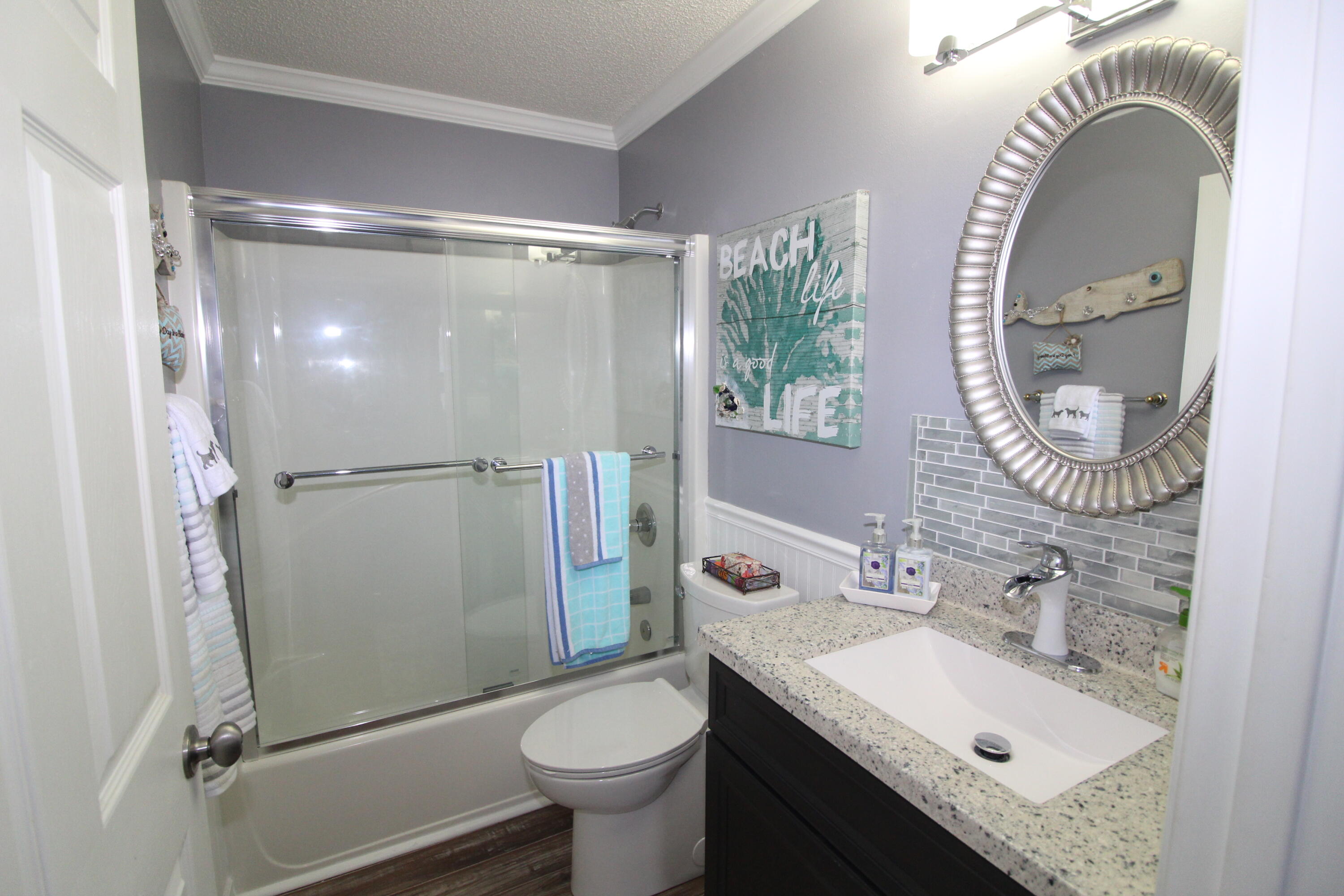 285 Payne Street, Unit 19B Miramar Beach, FL 32550 - Photo 14 of 24 a bathroom with a sink mirror toilet and shower