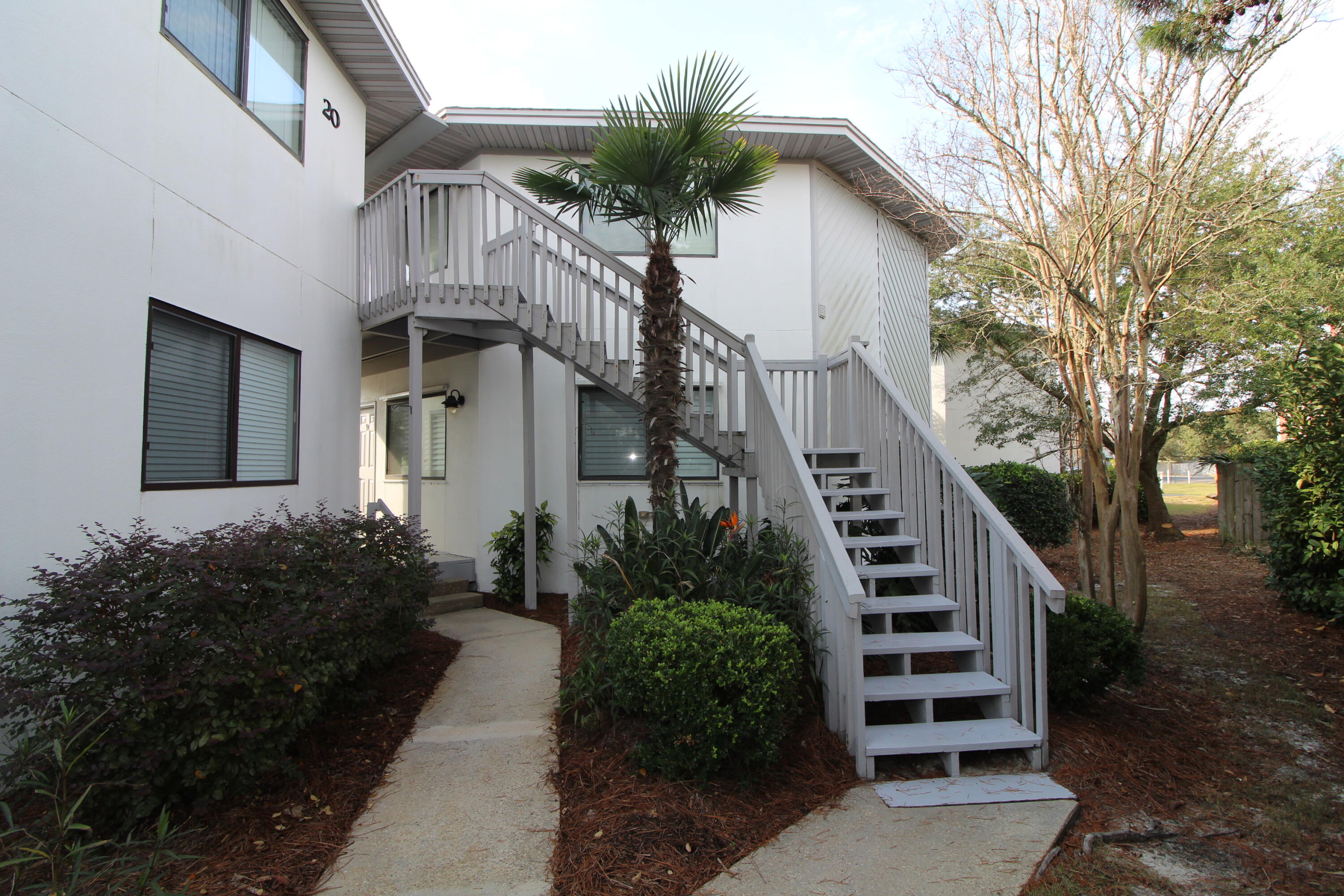 285 Payne Street, Unit 19B Miramar Beach, FL 32550 - Photo 16 of 24 a front view of a house with a garden