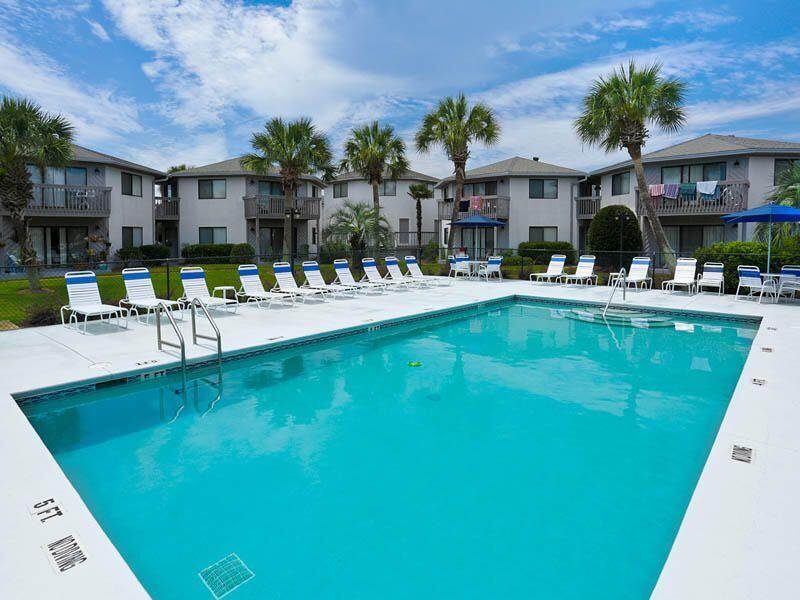 285 Payne Street, Unit 19B Miramar Beach, FL 32550 - Photo 21 of 24 a view of a house with pool porch and chairs
