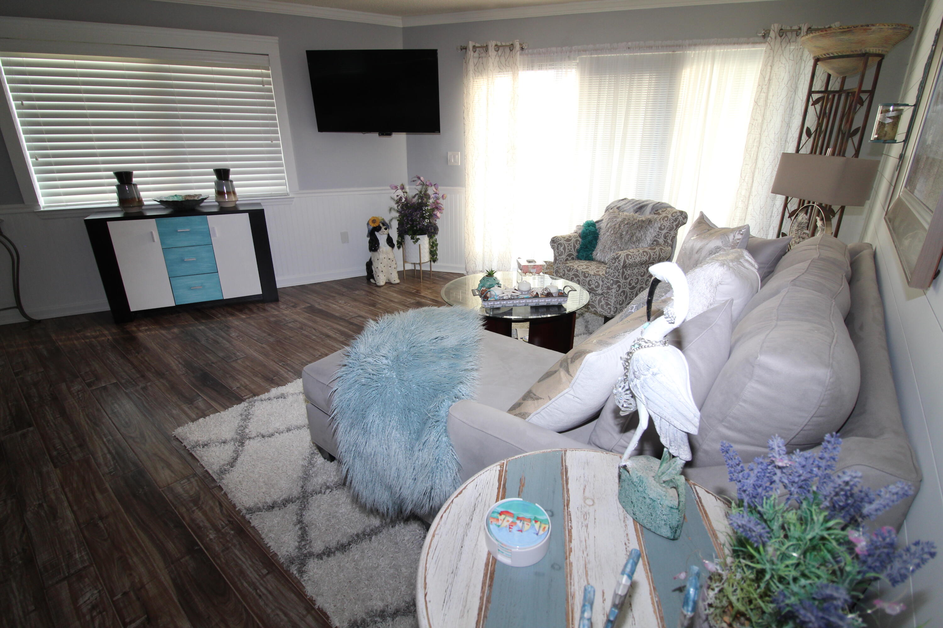 285 Payne Street, Unit 19B Miramar Beach, FL 32550 - Photo 3 of 24 a living room with furniture and a flat screen tv