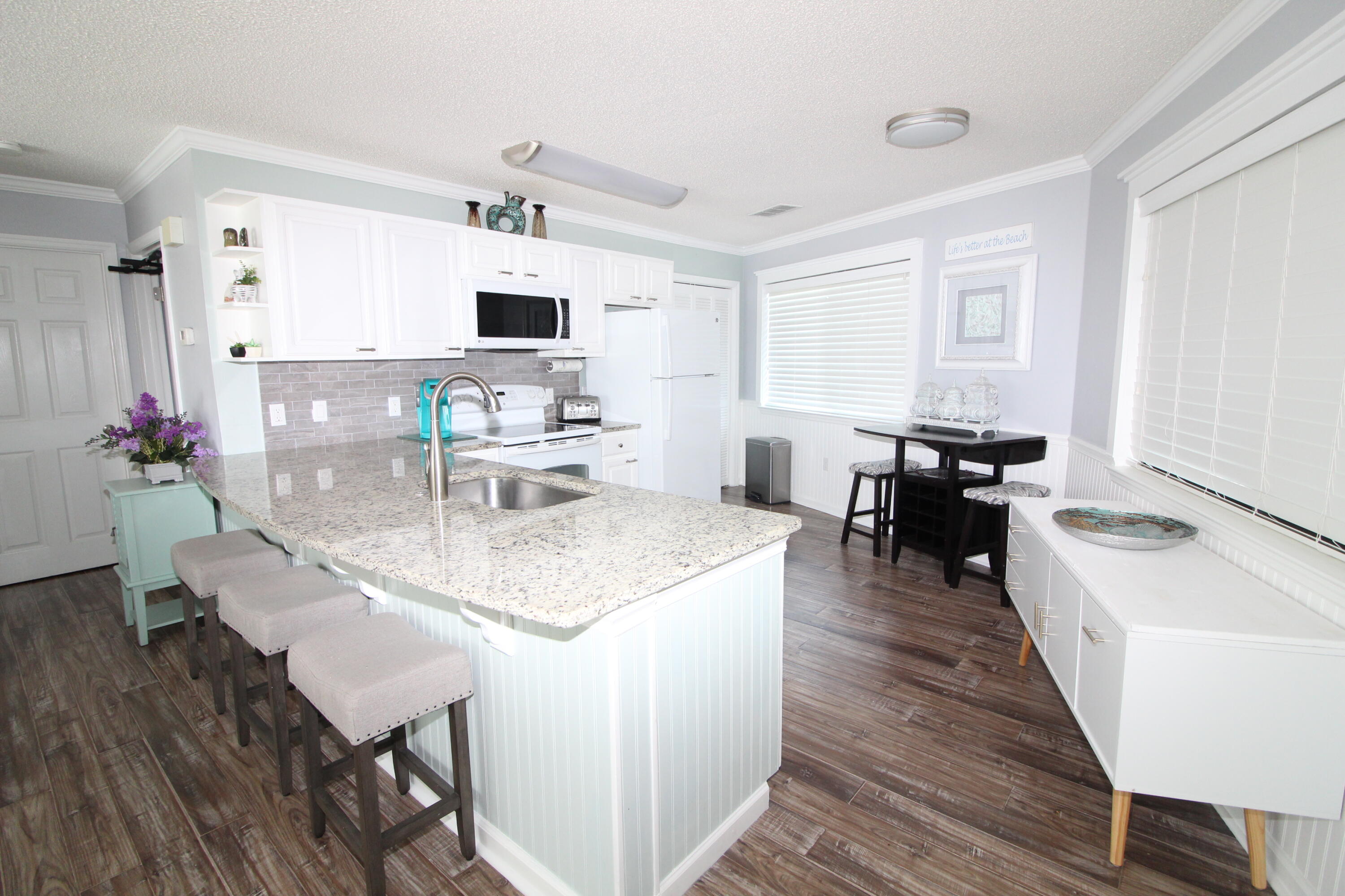 285 Payne Street, Unit 19B Miramar Beach, FL 32550 - Photo 4 of 24 a living room with fireplace furniture and a flat screen tv