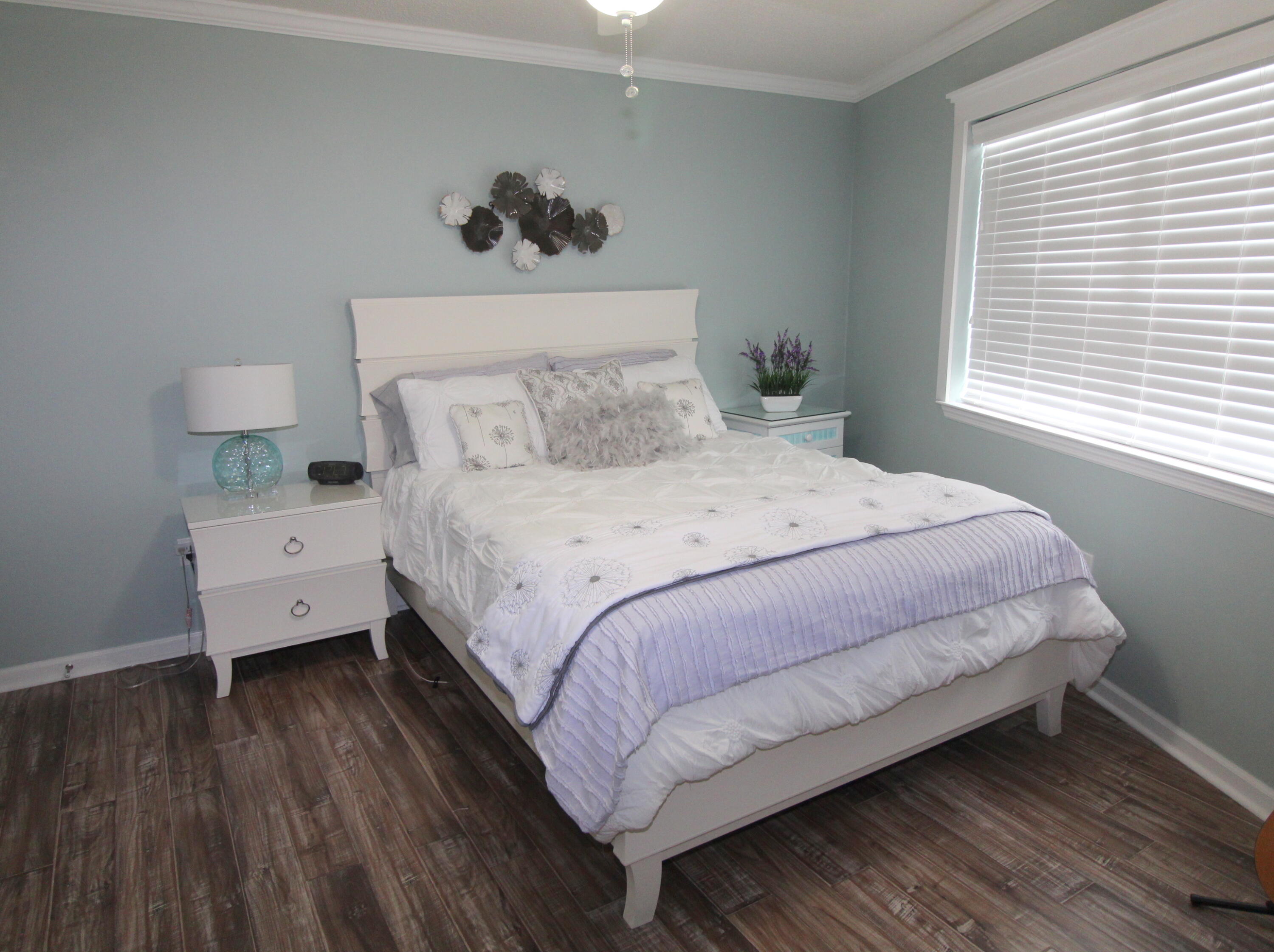 285 Payne Street, Unit 19B Miramar Beach, FL 32550 - Photo 6 of 24 a bedroom with a bed and a night stand