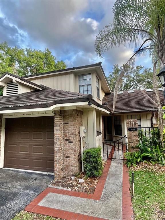 7608 Spring Bay Cove, Unit S Orlando, FL 32819 - Photo 1 of 20 a front view of a house with a garden