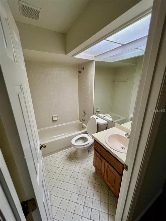 7608 Spring Bay Cove, Unit S Orlando, FL 32819 - Photo 12 of 20 a bathroom with a sink a toilet a mirror and vanity