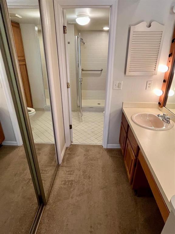 7608 Spring Bay Cove, Unit S Orlando, FL 32819 - Photo 14 of 20 a bathroom with a sink a toilet and a mirror