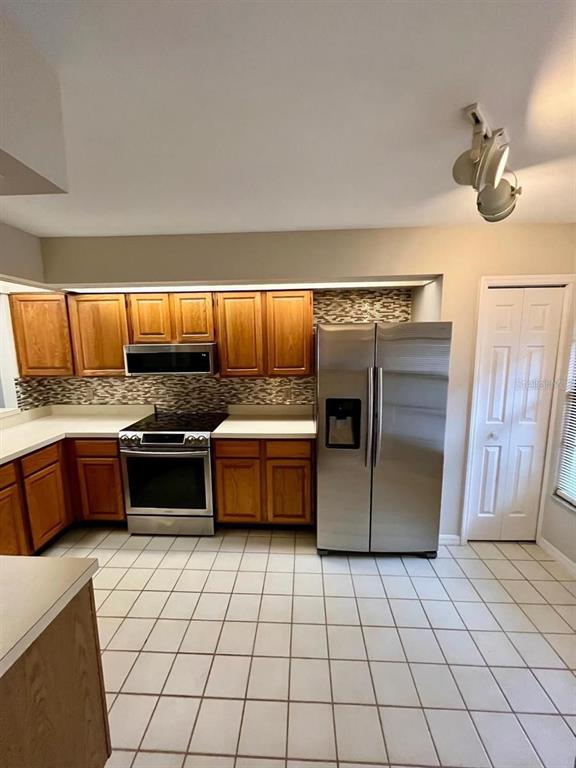 7608 Spring Bay Cove, Unit S Orlando, FL 32819 - Photo 4 of 20 a kitchen with stainless steel appliances a sink and a counter