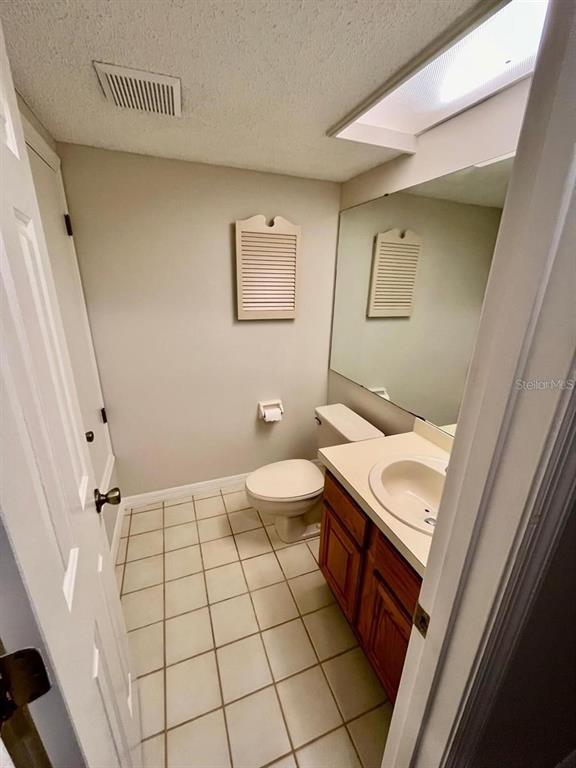 7608 Spring Bay Cove, Unit S Orlando, FL 32819 - Photo 10 of 20 a bathroom with a sink a toilet and a mirror