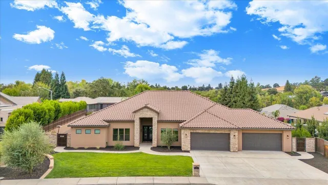 a front view of house with yard and green space