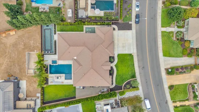 a view of house with swimming pool and outdoor seating