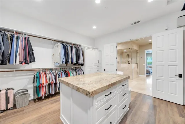 a bathroom with a granite countertop sink toilet a mirror and shower
